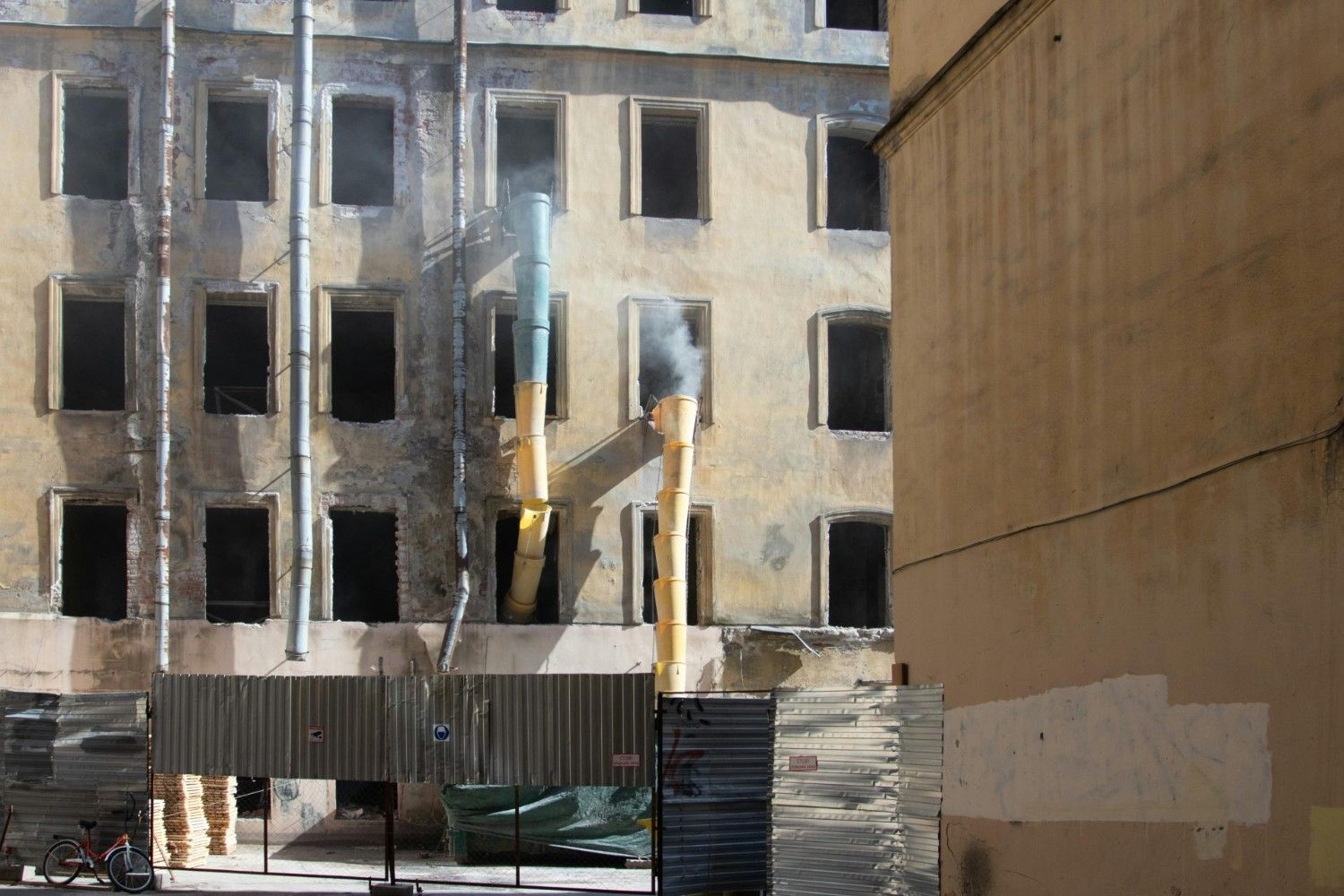 Abandoned building with renovation work in Saint Petersburg, Russia, showcasing exposed walls and pipes.